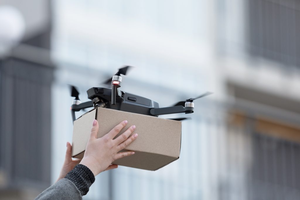 New drone with package box, delivery service modern electronic device, blurred background